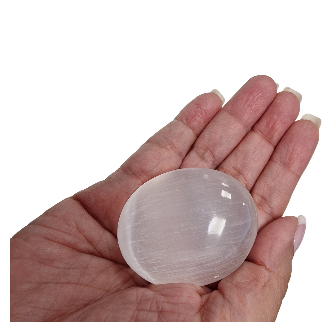Selenite Palm Stone 50 mm shown on hand for scale.