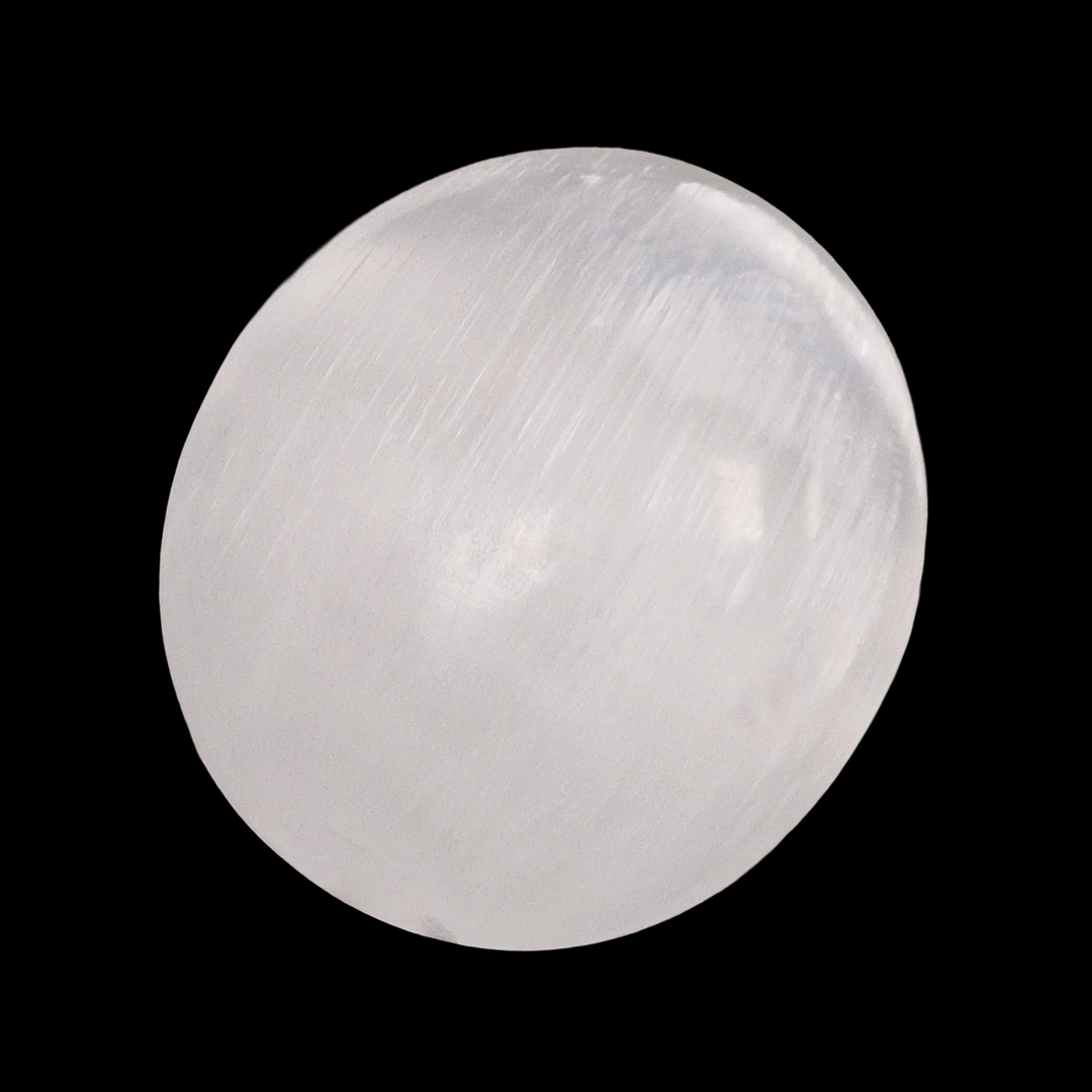 Selenite Palm Stone 70 mm shown on black background.