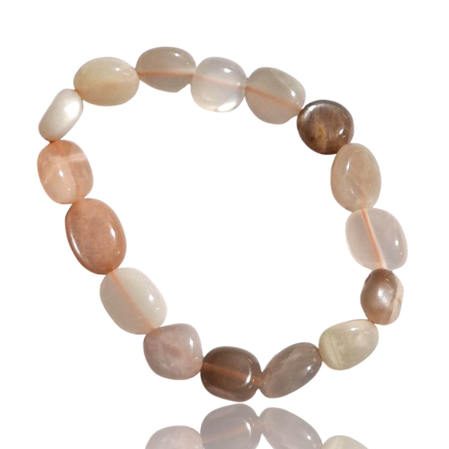 GeoFossils stretch nugget bracelet made from smooth, pastel-colored moonstone gems, ranging from soft peach and light pink to pale grey and creamy white. The stones are irregularly shaped and polished, giving the bracelet a natural, organic feel. The elastic design allows for an adjustable fit, and the soft, luminous glow of the moonstones creates a subtle, ethereal look.