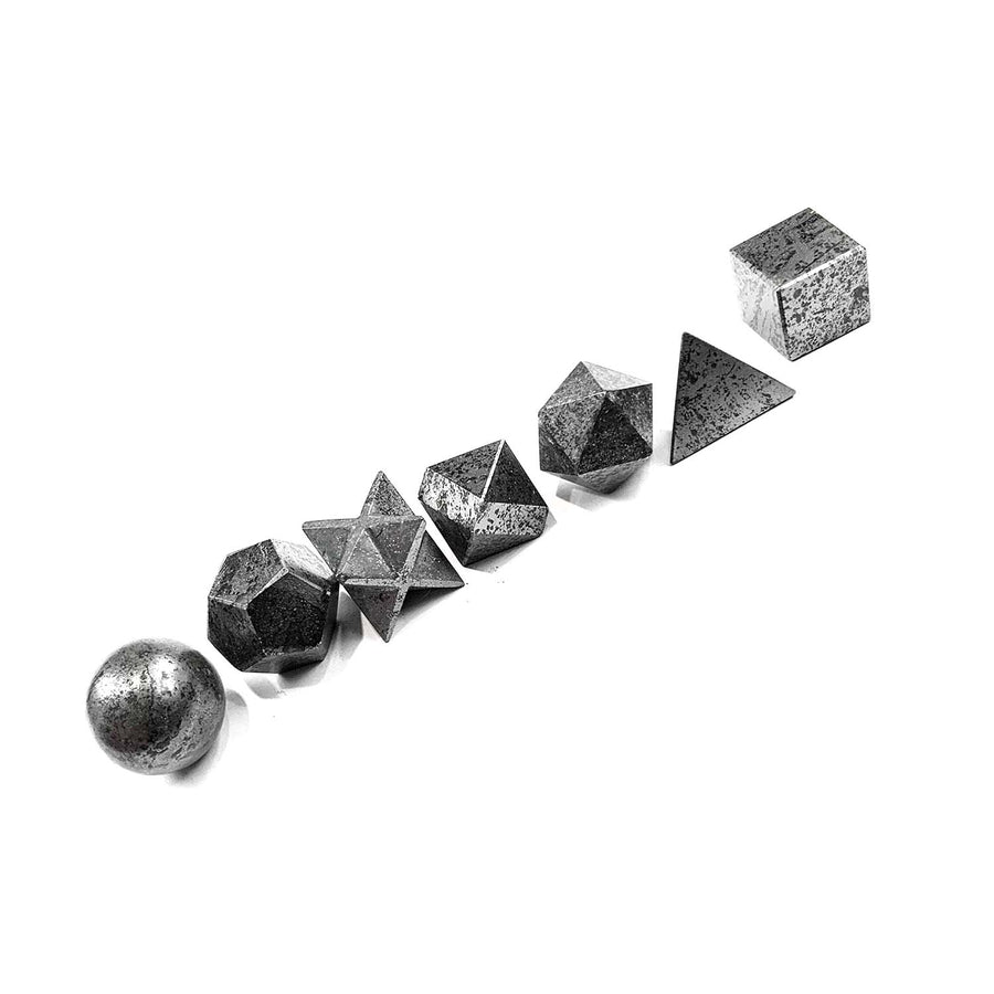Magnetite Platonic Solids Set by GeoFossils – 7-piece set featuring black geometric shapes, perfect for grounding, balance, and connecting with the Root Chakra, associated with the Earth element.