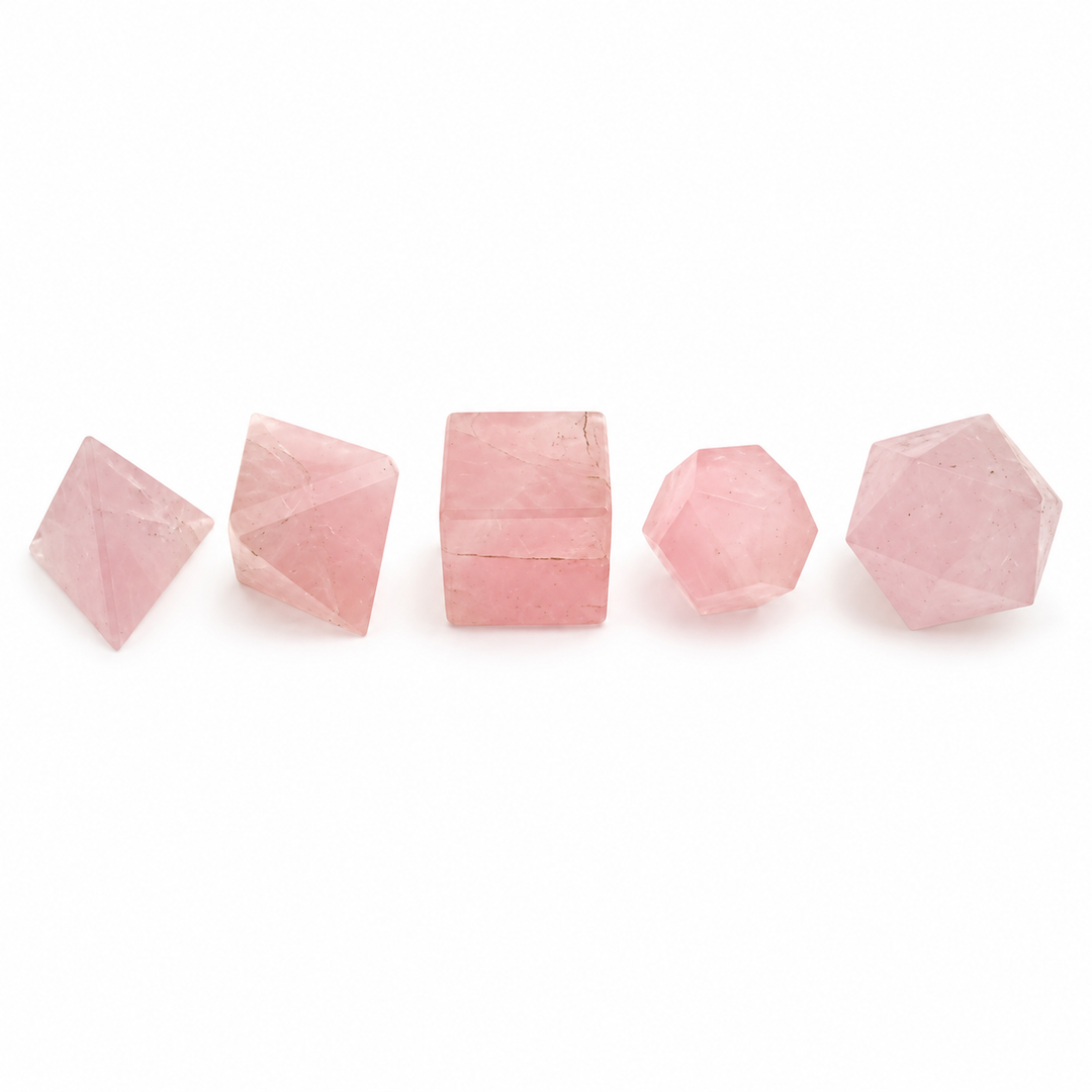 GeoFossils five-piece Rose Quartz Platonic set with polished pink tetrahedron, octahedron, cube, dodecahedron and icosahedron on a white background.