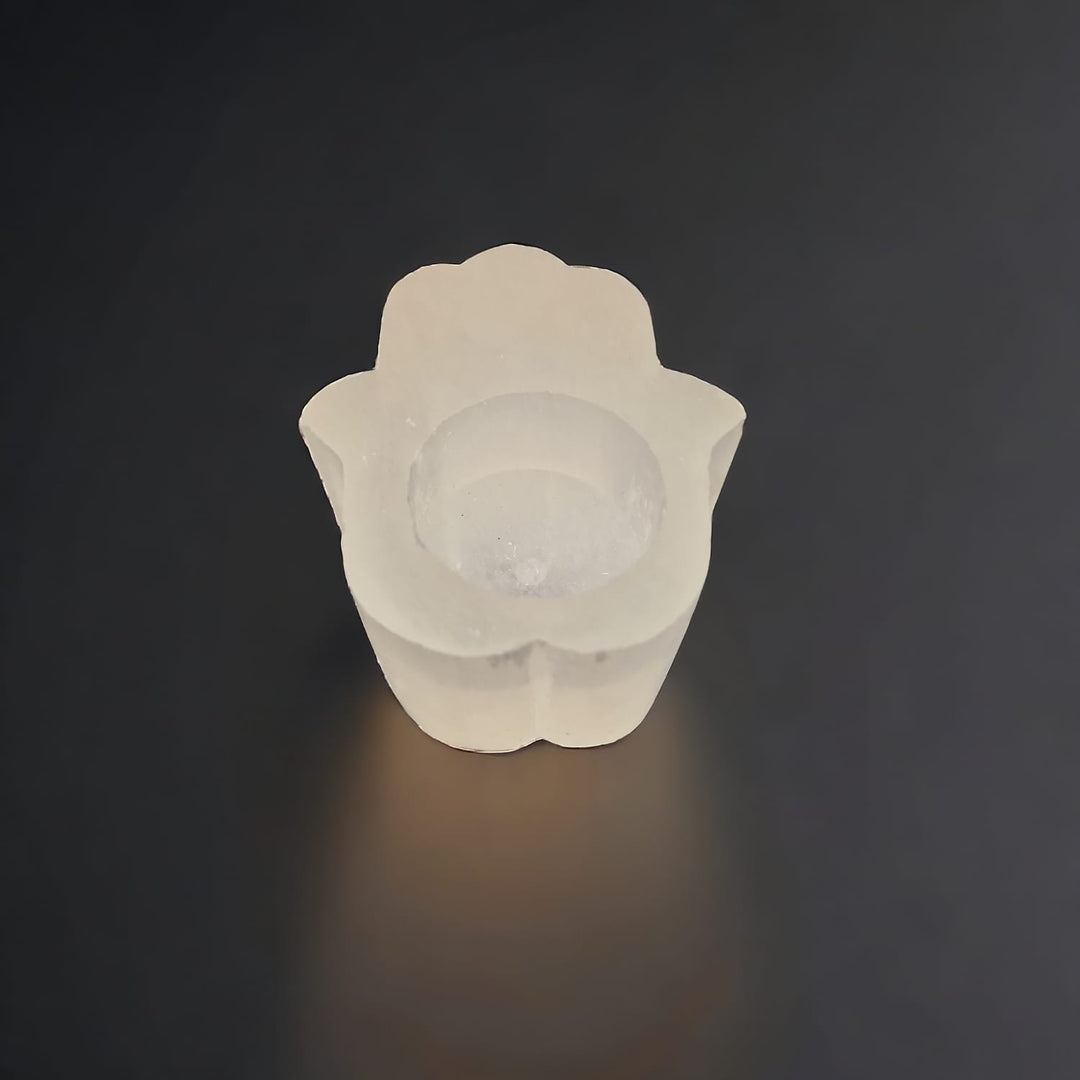 Selenite Hamsa Hand Tealight Holder with protective carved design, ideal for spiritual spaces and crystal cleansing.