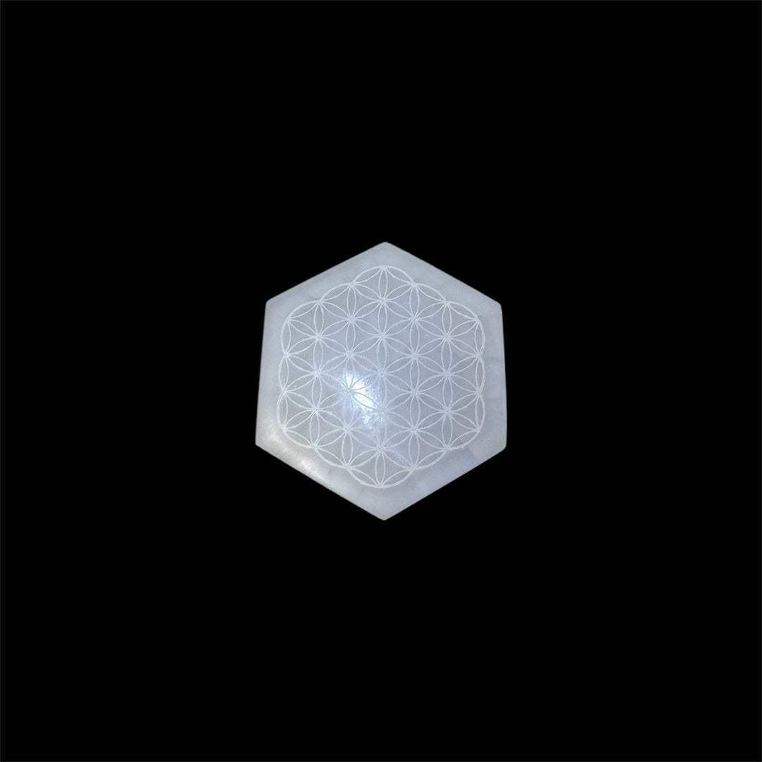 Flower of Life Selenite Charging Disc in hexagonal form, engraved with sacred geometry pattern for spiritual cleansing, energy balancing, and crystal recharging.