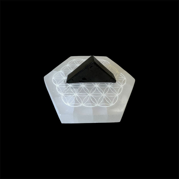 Flower of Life Selenite Charging Disc with Alienite crystal placed on top for demonstration purposes; Alienite not included with the disc