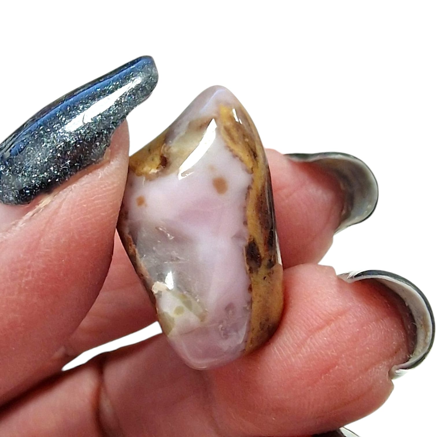 GeoFossils Bustamite Rare Tumble Stone, a soft pink to peach crystal for emotional healing, self-love, and gentle transformation.