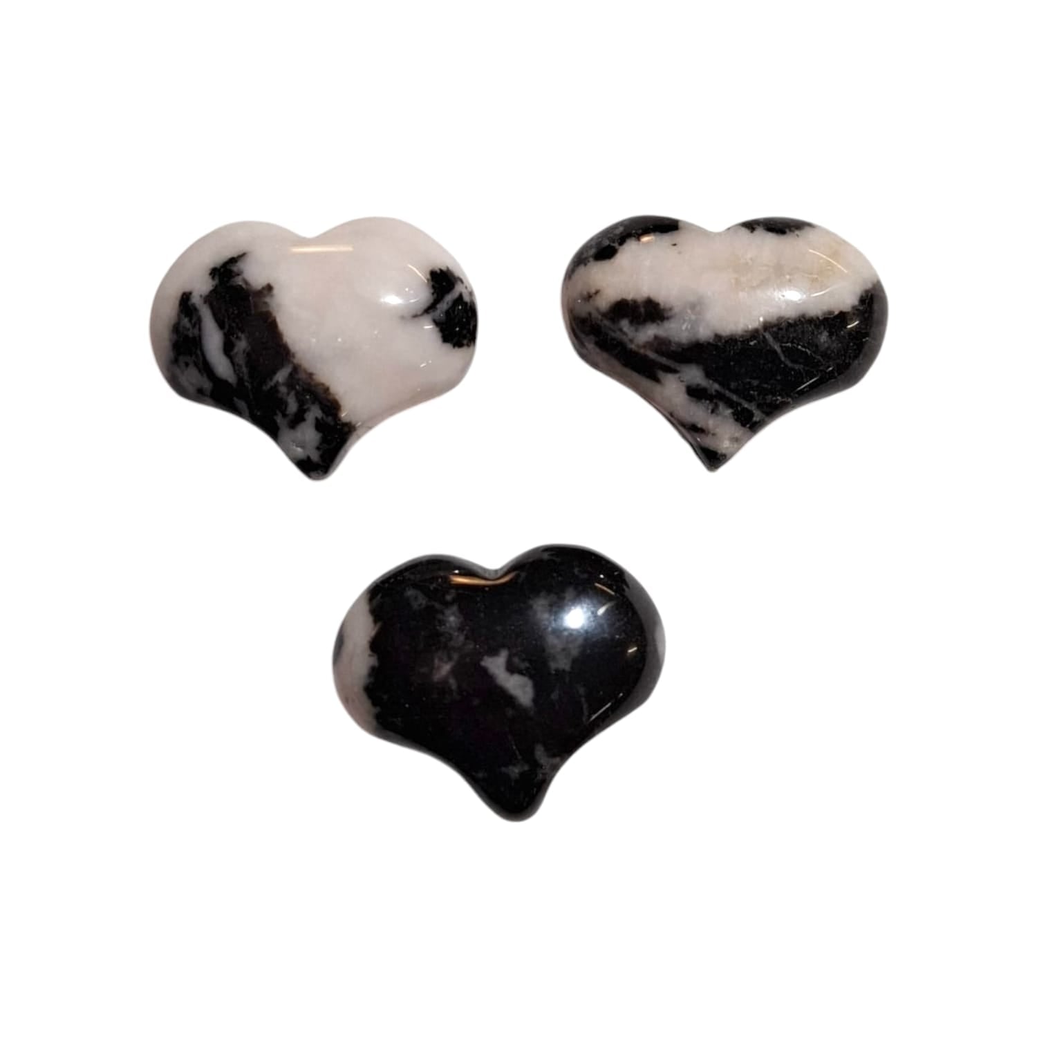 A small, polished puff heart crafted by GeoFossils from zebra jasper, showcasing a striking black and white striped pattern reminiscent of zebra markings. The heart has a smooth, rounded shape, highlighting the bold, contrasting bands of colour. The natural, earthy appearance of the zebra jasper heart evokes a sense of grounding, balance, and harmony with nature.