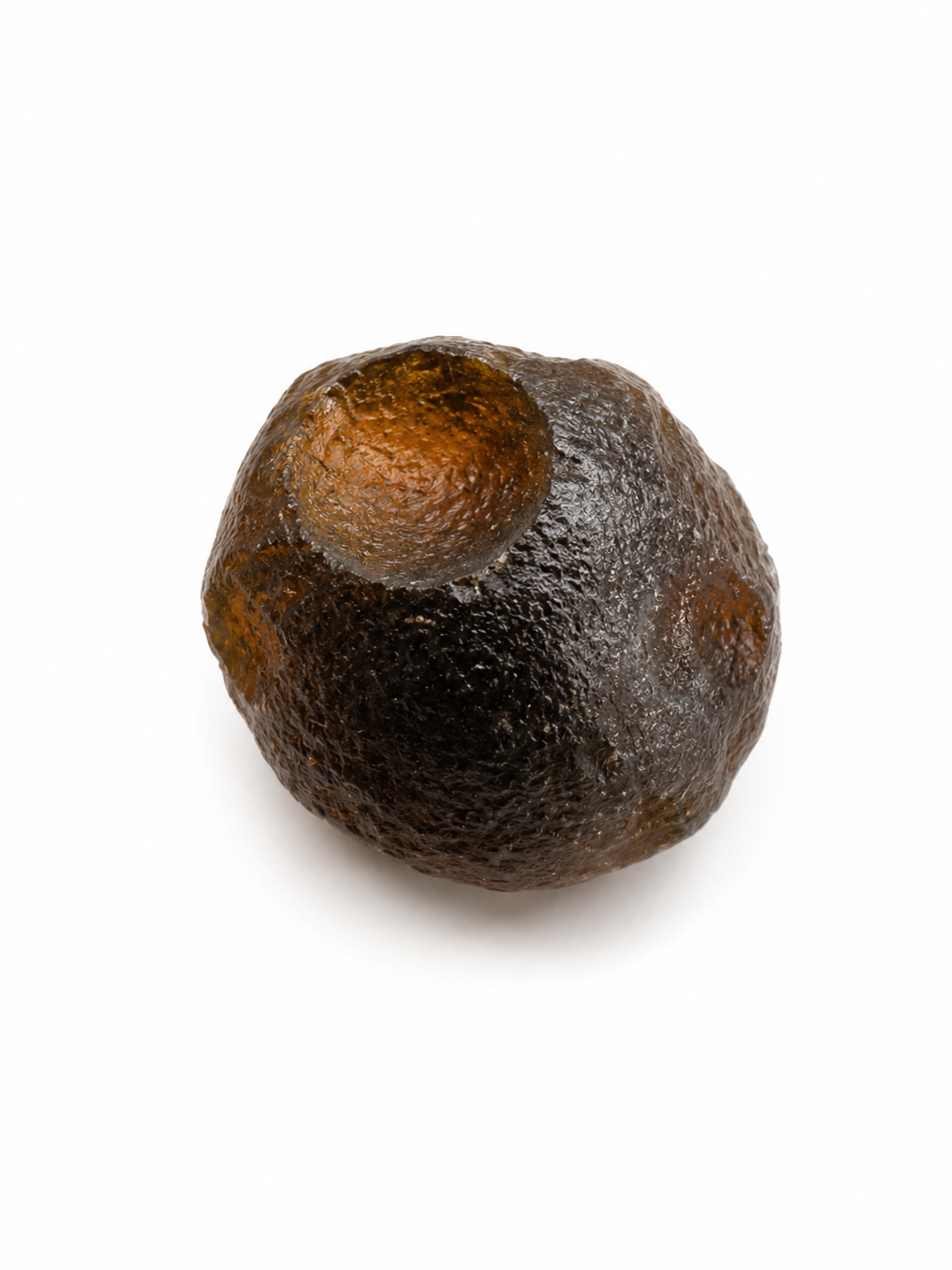 Australite specimen shown on hand for scale.