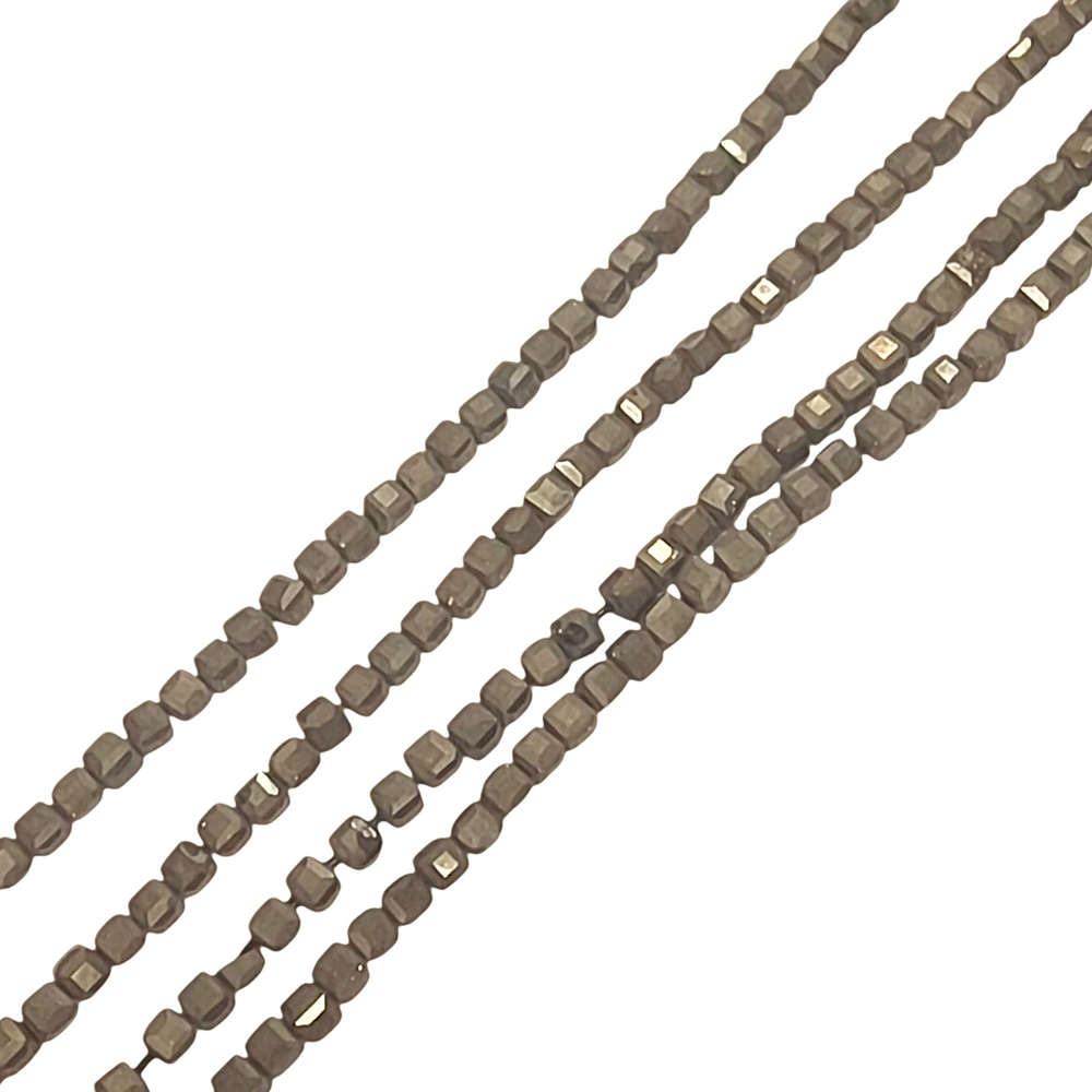 Close-up of Pyrite 4mm cube beads showing metallic detail and texture