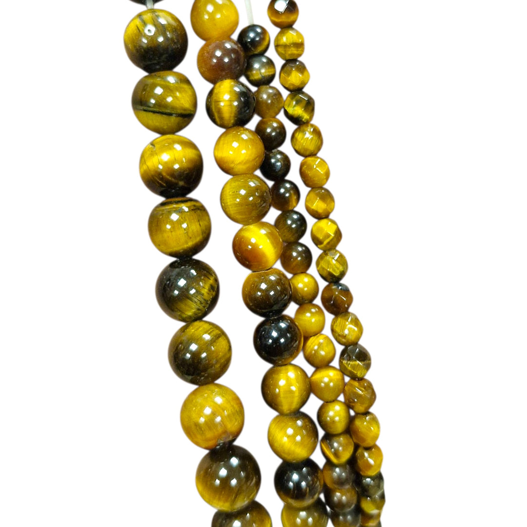 Gold Tigers Eye round beads held in hand for scale group