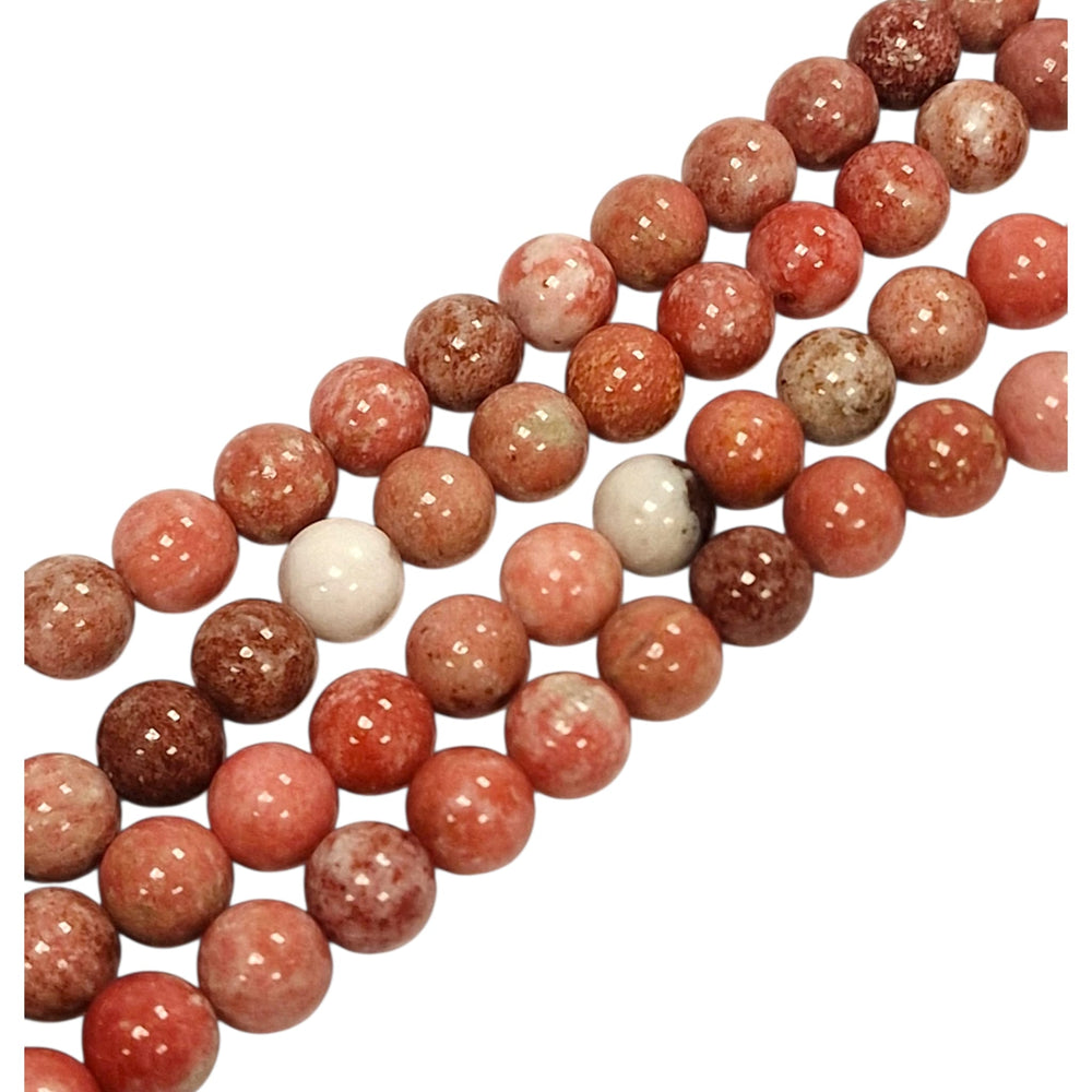 Close-up of Pink Thulite round beads showing natural colour and texture