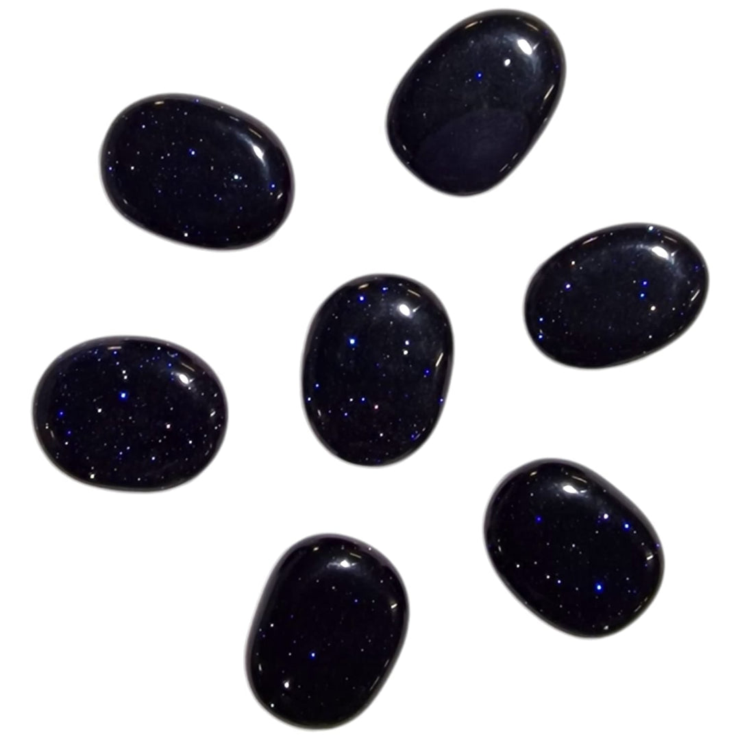 Blue Goldstone Mini Oval – a manmade deep blue crystal with a glittering surface, known for boosting ambition, confidence, and creativity. Ideal for inspiring motivation and achieving success.