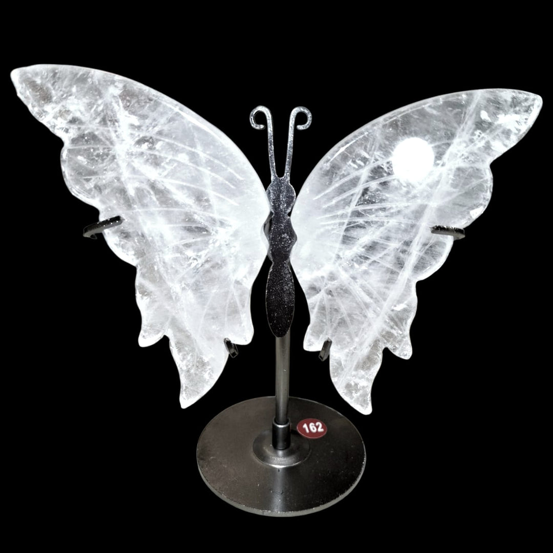 Crystal Quartz butterfly carving mounted on metal stand, symbolising transformation, clarity, and spiritual elevation