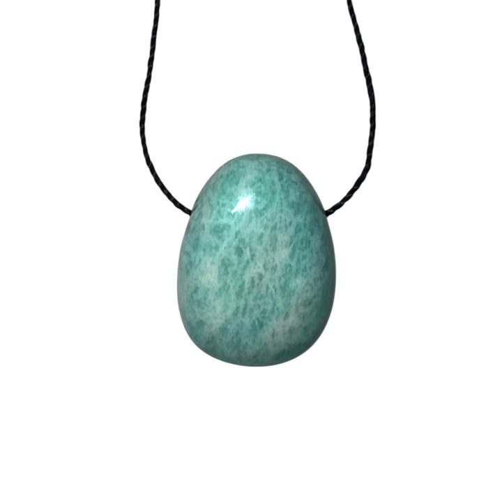Polished Amazonite drilled tumblestone threaded with black cord, showcasing its calming blue-green hues