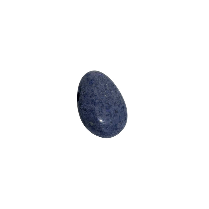 Close-up of Blue Coral drilled tumblestone showing fossilised structure with soft blue-grey colouring and natural patterning