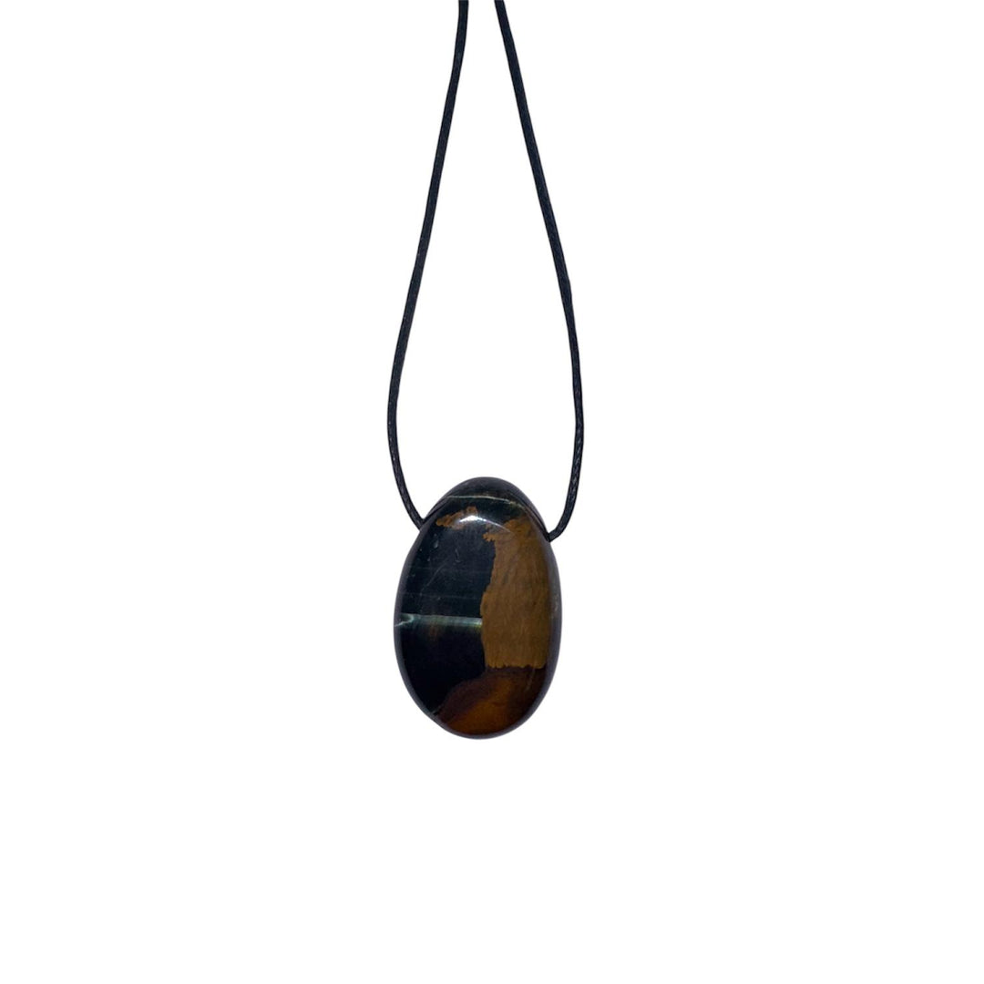 Polished Blue Tiger’s Eye pendant with deep midnight blue tones and silky chatoyancy, displayed on a black cotton cord.