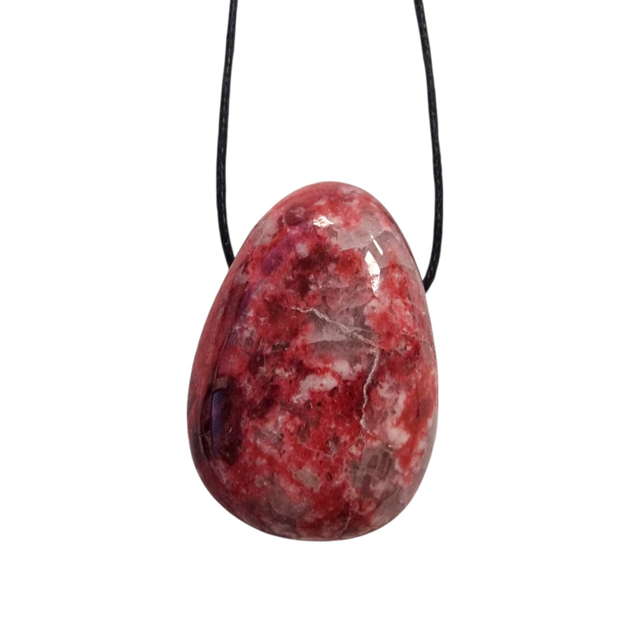 Mottled raspberry pink Thulite tumble stone pendant with quartz inclusions, presented on a black cotton cord."