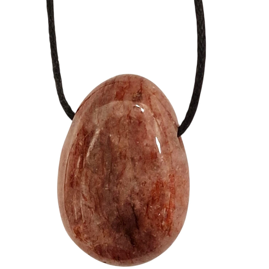 Red Aventurine tumble stone pendant with warm terracotta tones and subtle shimmer, displayed on a black cotton cord.