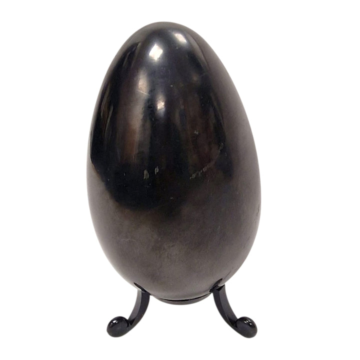 100mm Shungite egg on white background, smooth crystal symbolising renewal and balance