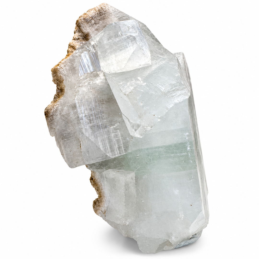 Green Apophyllite crystal cluster from Pune, India, displaying intersecting crystal structures, pale green transparency and geometric terminations.