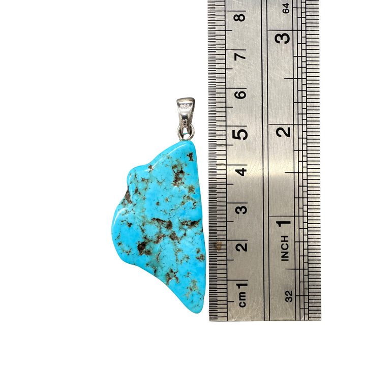 GeoFossils Kingman Mine Turquoise pendant photographed beside a centimetre ruler to demonstrate its approximate 4.5 cm total height excluding the sterling silver bail