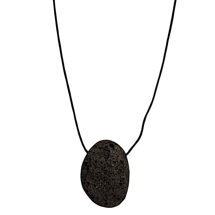 Lava drilled tumble stone pendant on a black cord – volcanic grounding stone for stability, strength and transformation