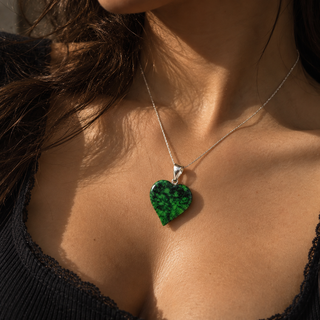 GeoFossils Maw Sit Sit heart pendant worn around the neck, showcasing its vibrant green and black patterning and sterling silver fitting as gemstone jewellery.
