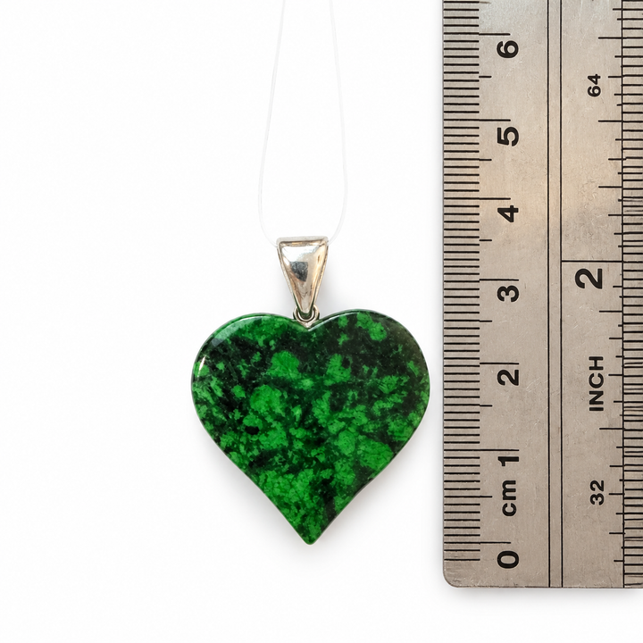 GeoFossils Maw Sit Sit heart pendant displayed beside a metric ruler, measuring approximately 4 cm in total height including the sterling silver bail.