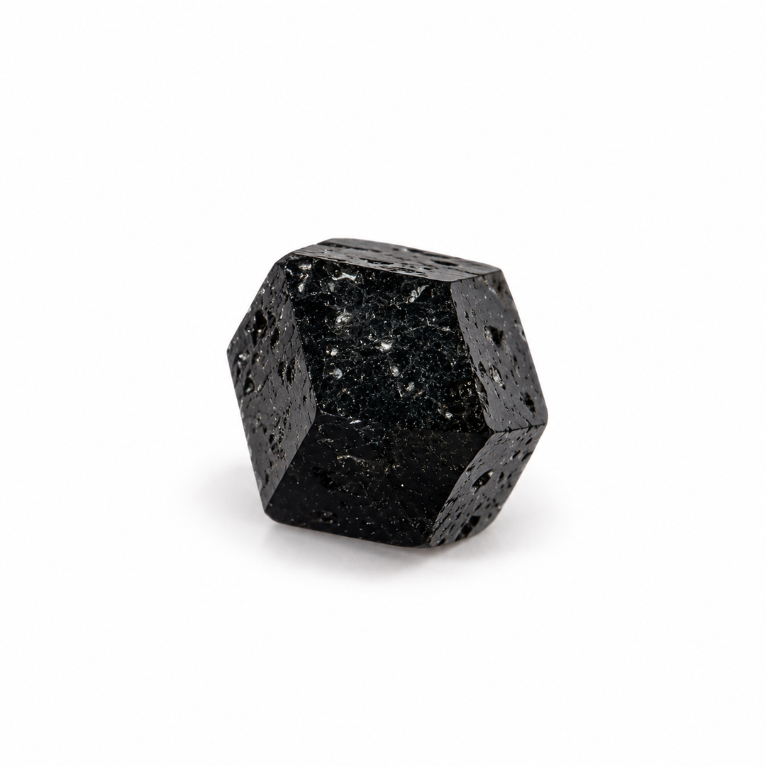 Natural black Melanite Garnet crystal featuring angular geometric faces and a dark lustrous surface, isolated on a white background.
