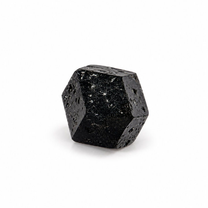 Natural black Melanite Garnet crystal featuring angular geometric faces and a dark lustrous surface, isolated on a white background.