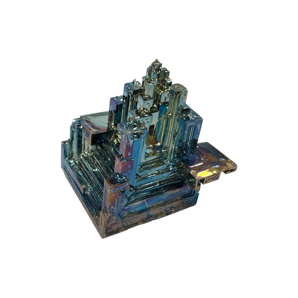 Medium Bismuth mineral specimen in hand to show size, displaying blue, green, and pink hues.