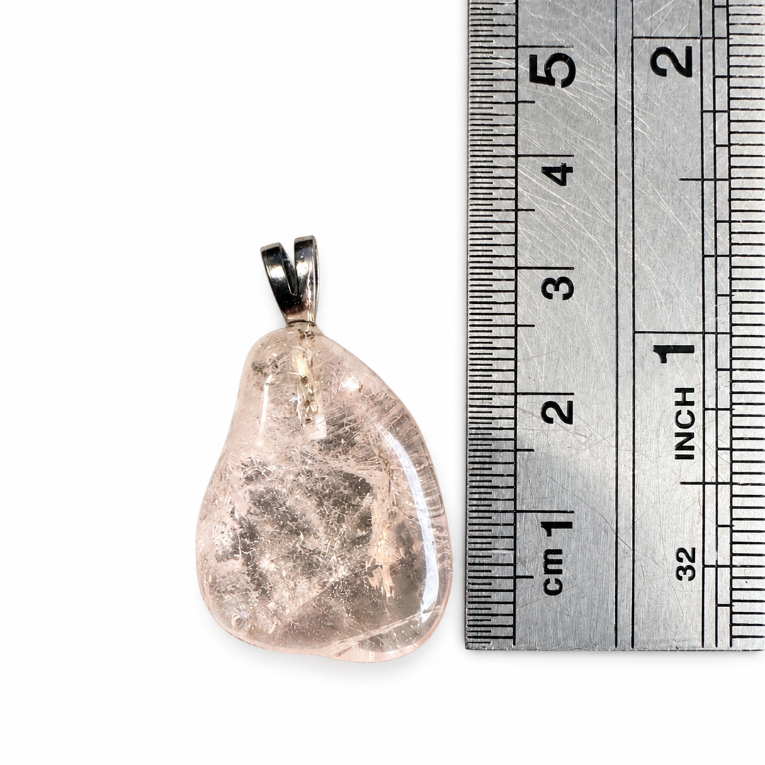 GeoFossils Morganite Tumblestone Pendant positioned beside a metal ruler with centimetre markings, showing the pendant's approximate 3 cm total height including the sterling silver bail.