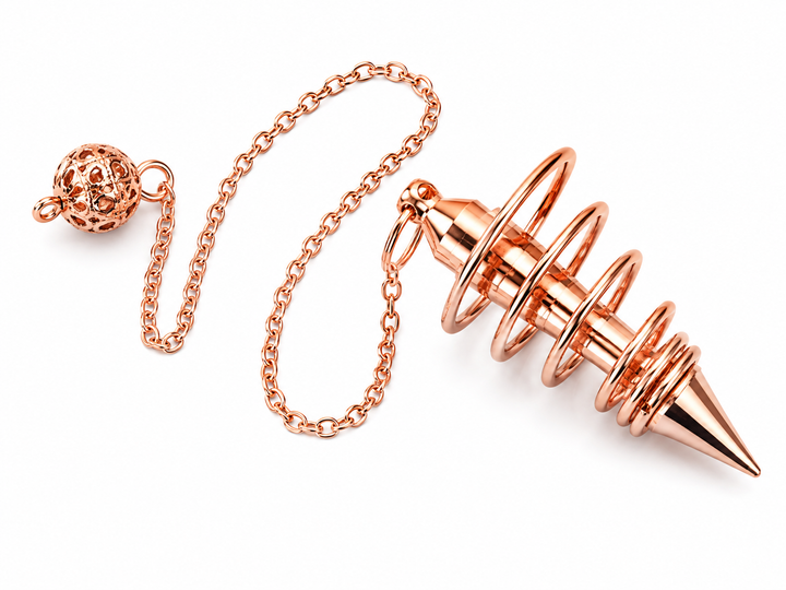Rose gold metal pendulum necklace with a pointed weighted tip, coiled spring design, and a small decorative ball charm on a white background.