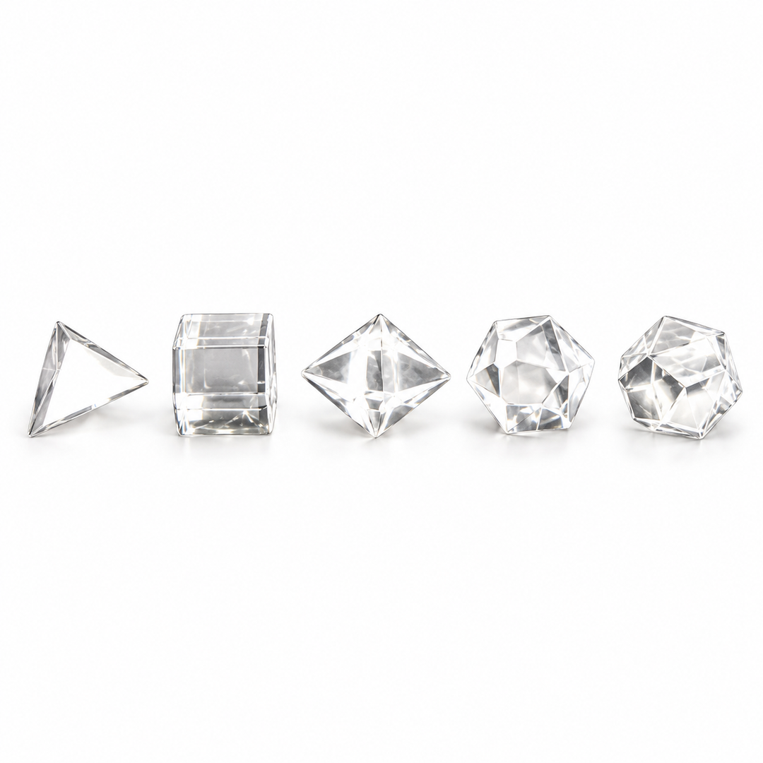 Five polished Clear Quartz Platonic solids arranged in a row on a white background — GeoFossils.