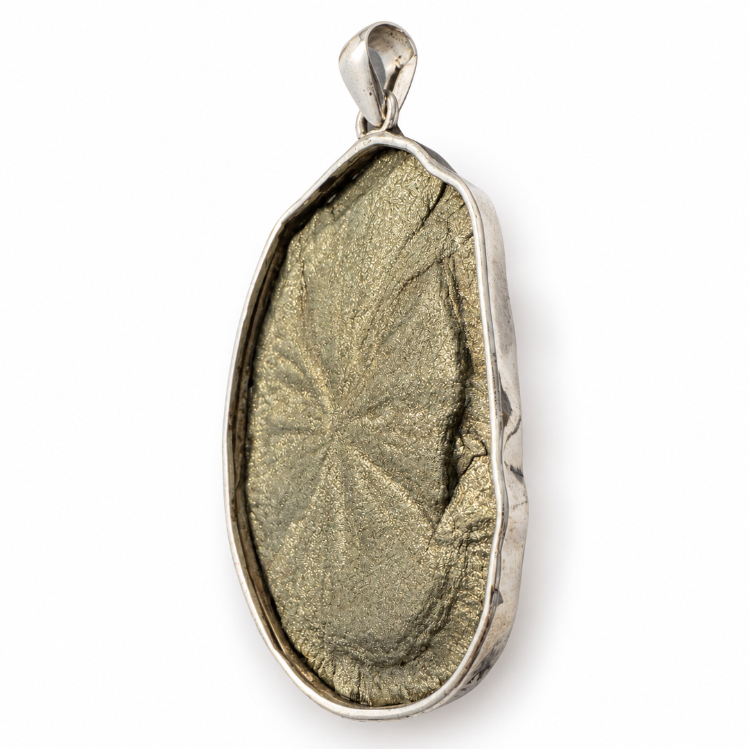Low-angle profile of a Pyrite Sun pendant highlighting the natural mineral disc thickness and handcrafted 925 sterling silver setting.