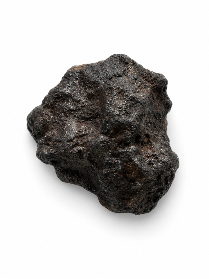 Raw plutonic angrite meteorite displaying natural surface texture.