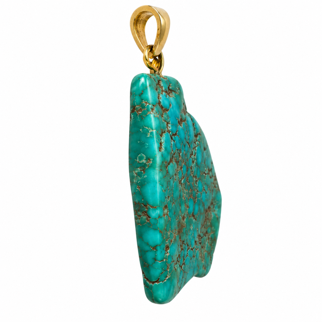 GeoFossils Royston Turquoise pendant held in a hand at an angle, showcasing the gemstone's polished surface, natural blue-green colouring, grey-brown matrix and thickness.