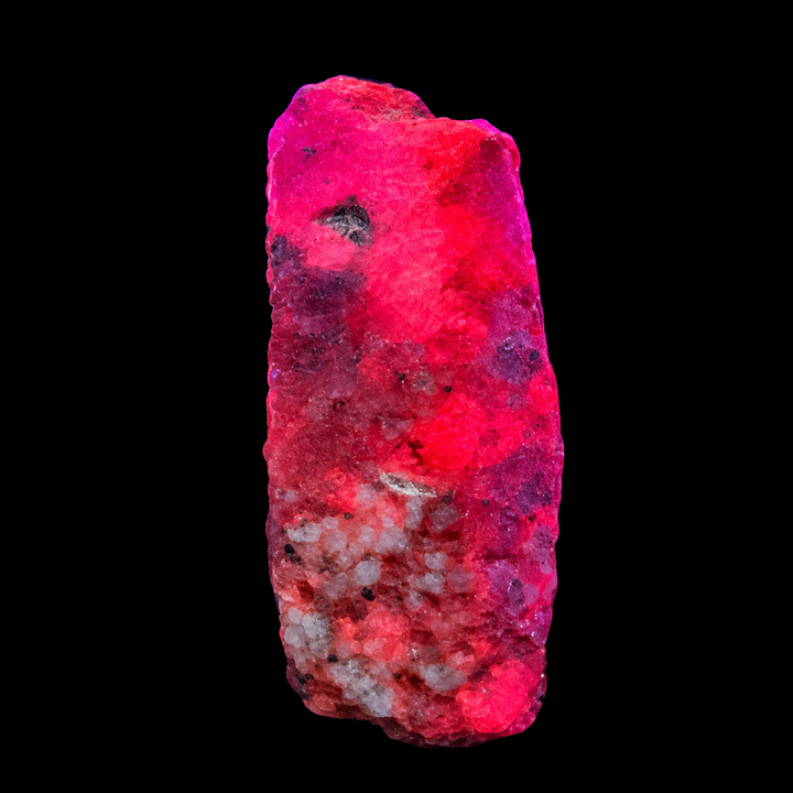 GeoFossils Ruby mineral specimen 207 displaying bright red-pink fluorescence under UV light against a black background.