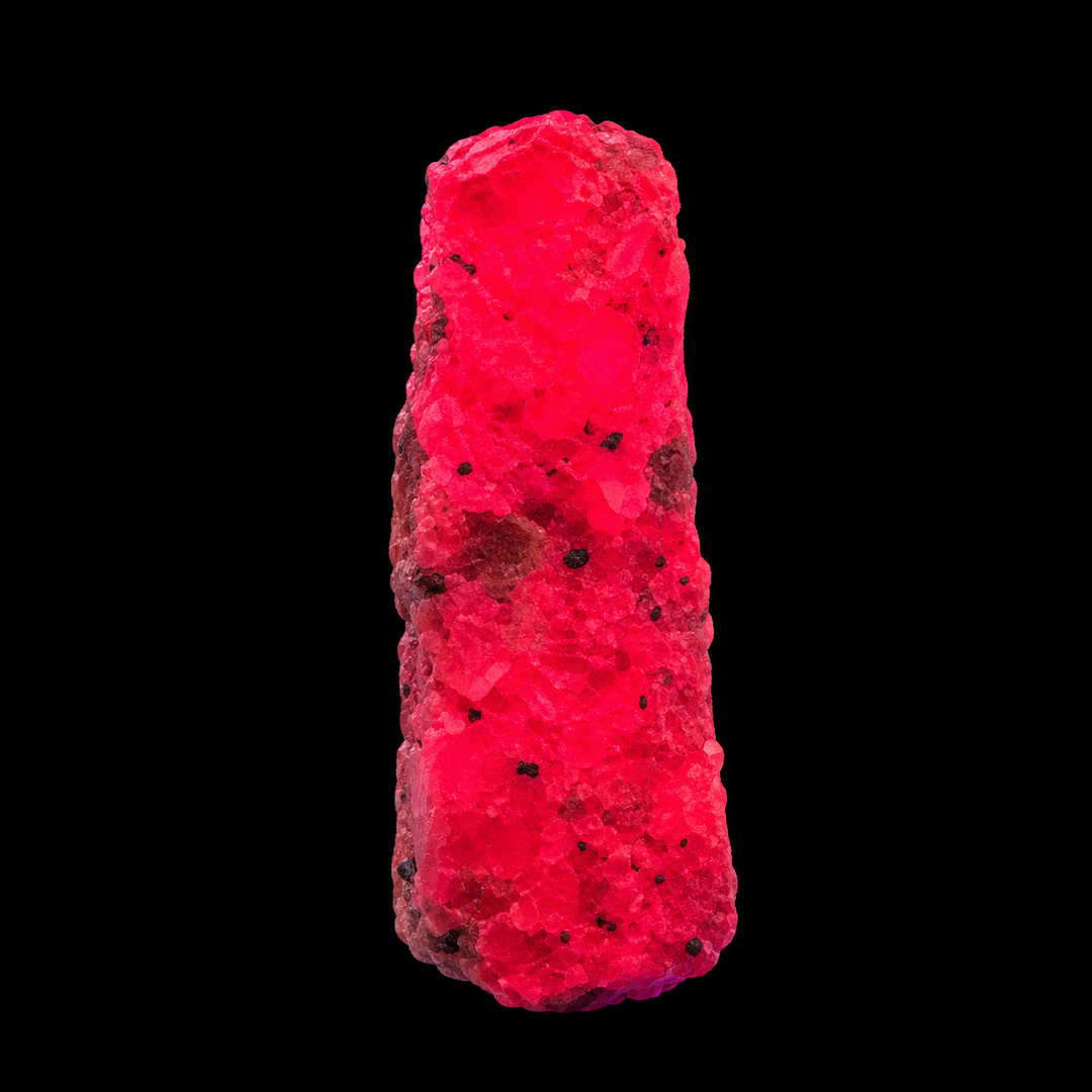 GeoFossils Ruby mineral specimen 211 displaying bright red-pink fluorescence under UV light against a black background.