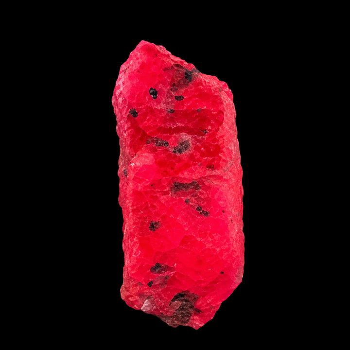 GeoFossils Ruby mineral specimen 212 displaying bright red-pink fluorescence under UV light against a black background.