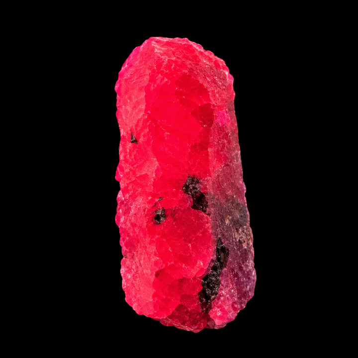 GeoFossils Ruby mineral specimen 213 displaying bright red-pink fluorescence under UV light against a black background.