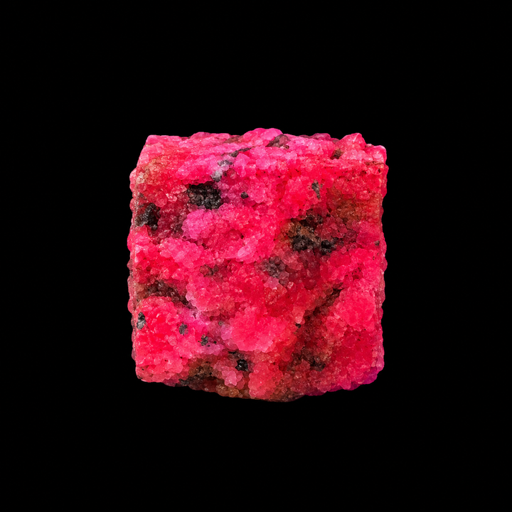 GeoFossils Ruby mineral specimen 216 displaying bright red-pink fluorescence under UV light against a black background.