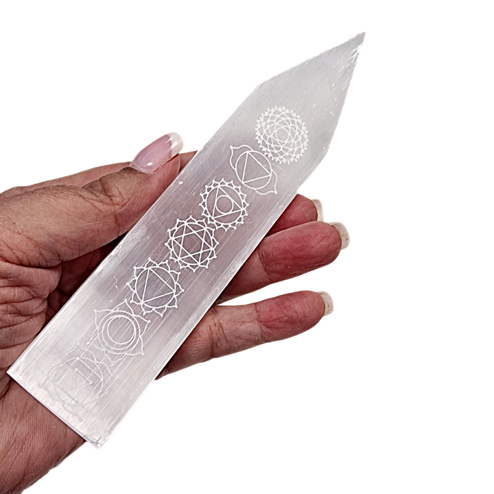 Selenite Chakra Blade – Engraved Polished Wand shown on hand for scale.