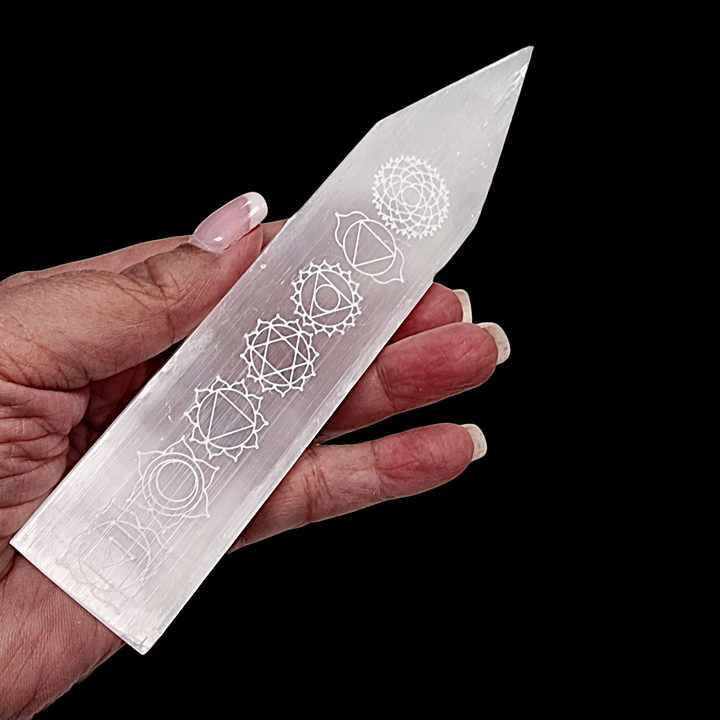Selenite Chakra Blade – Engraved Polished Wand shown on hand for scale.
