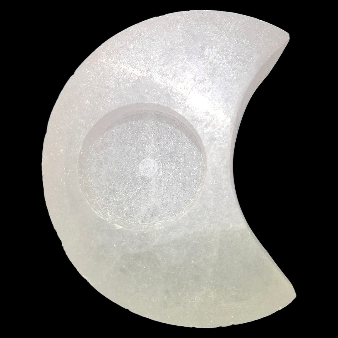 Crescent Moon Selenite Tealight Holder glowing softly, symbolising lunar energy, intuition, and spiritual cleansing.