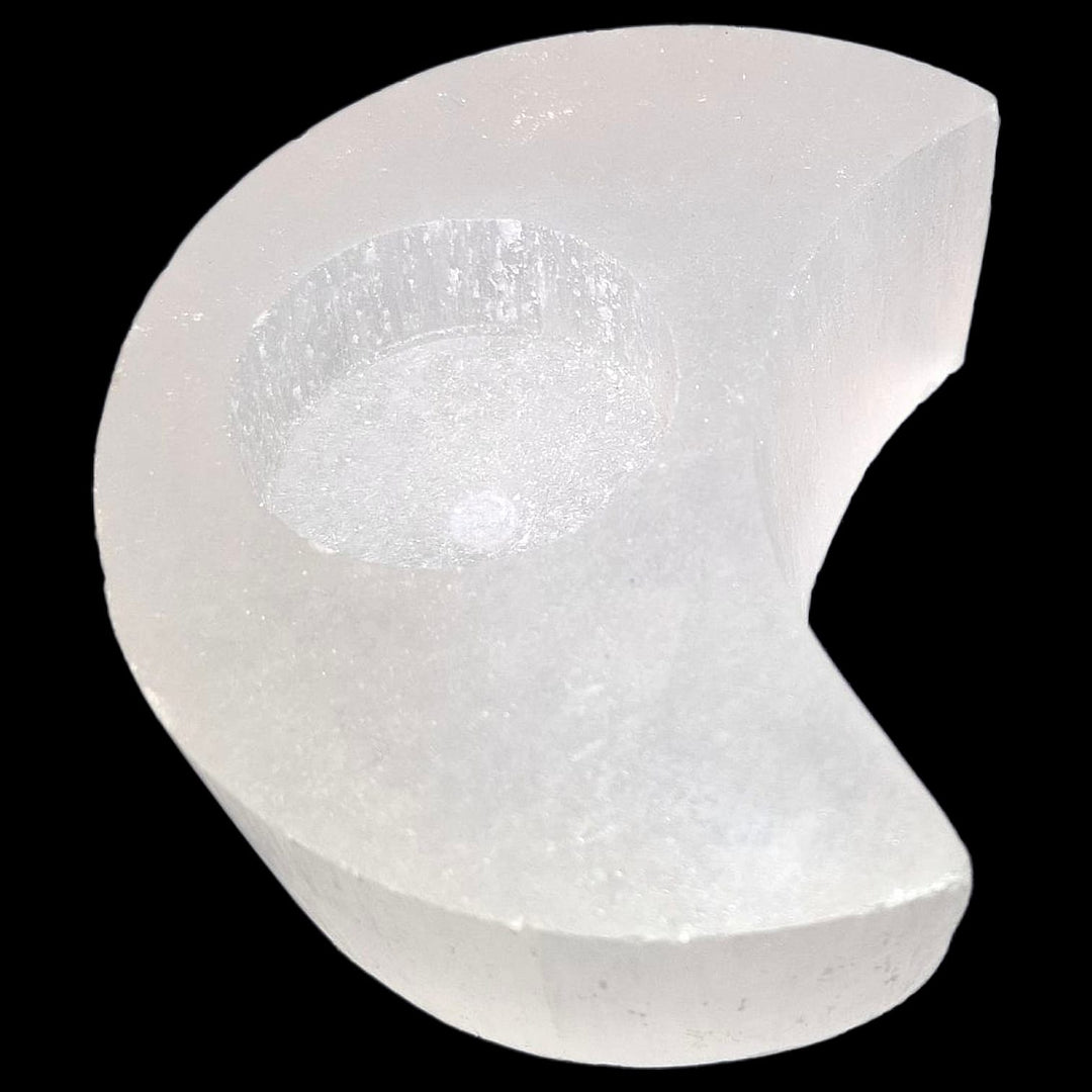 Crescent Moon Selenite Tealight Holder glowing softly, symbolising lunar energy, intuition, and spiritual cleansing.