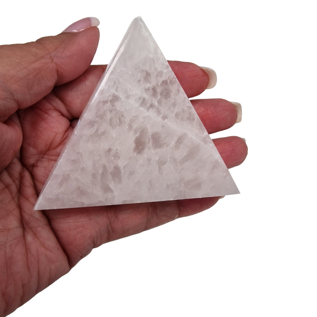 Selenite Triangle Charging Disc 80mm shown on hand for scale.
