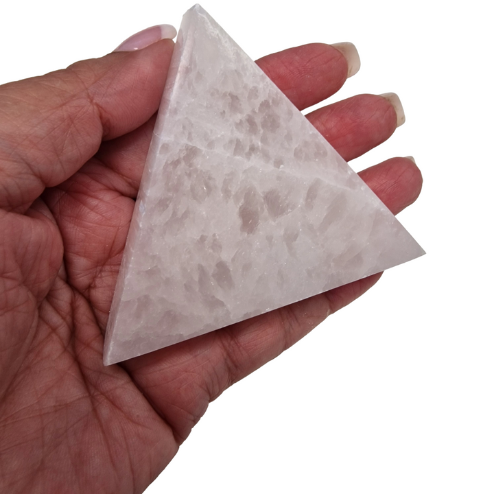 Selenite Triangle Charging Disc 80mm shown on hand for scale.