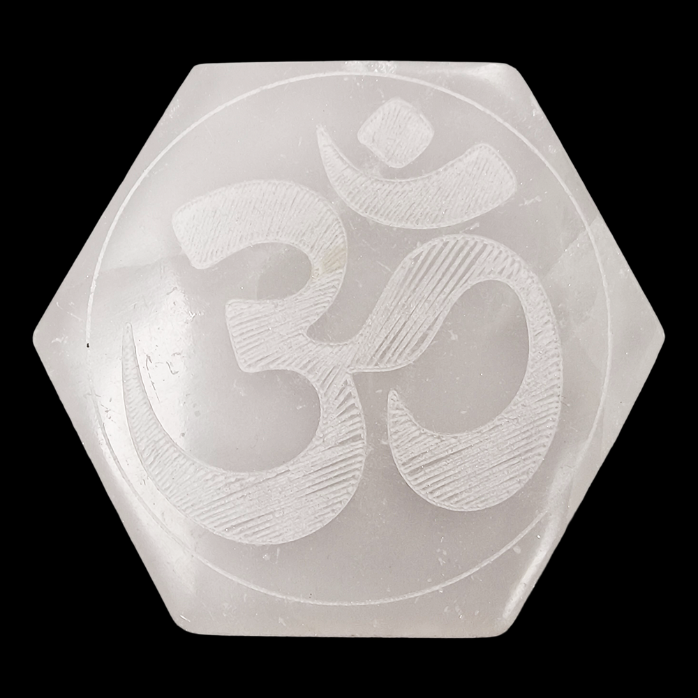 Selenite Hexagon Ohm Engraved Charging Disc shown on black background.