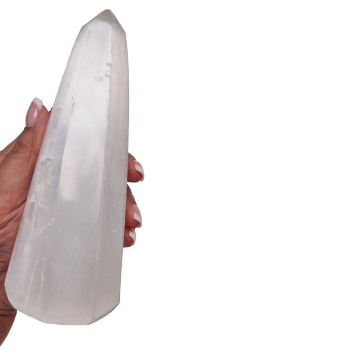 Selenite 8-Sided Obelisk 18cm shown on hand for scale.