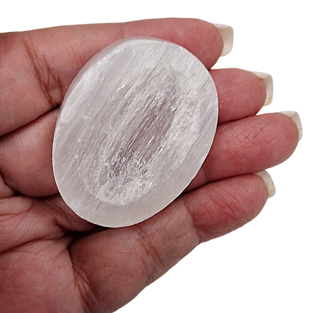 Selenite Worry Stone crystal shown on hand for scale.